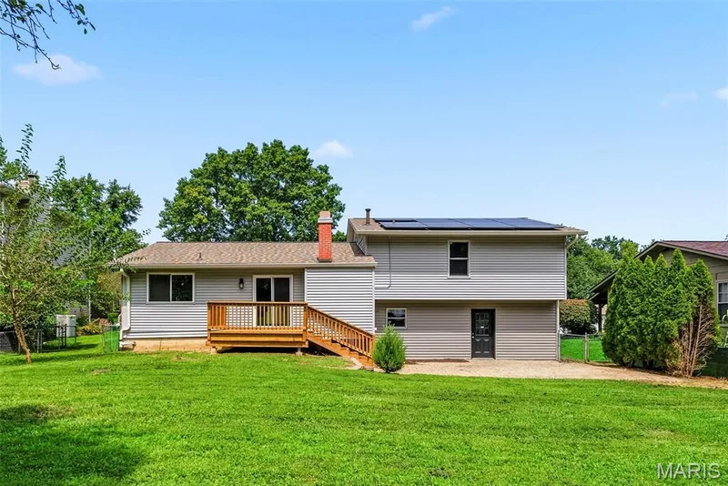 Rear exterior showcasing siding, soffits, fascia and gutters replaced in 2022, with a newer roof installed in 2023. — 3034 Willow Wood Drive, St Charles, MO 63303
