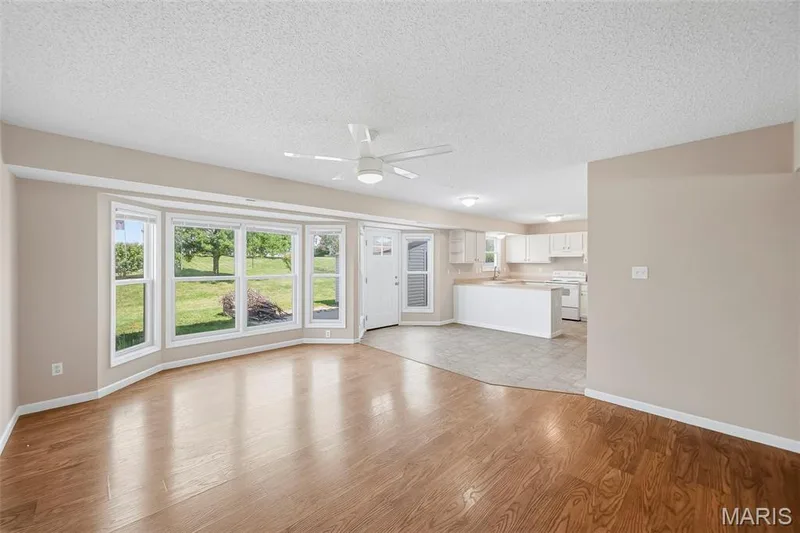 Living room opens to breakfast room and kitchen — 15 Tyler Court #2101A, Wentzville, MO 63385