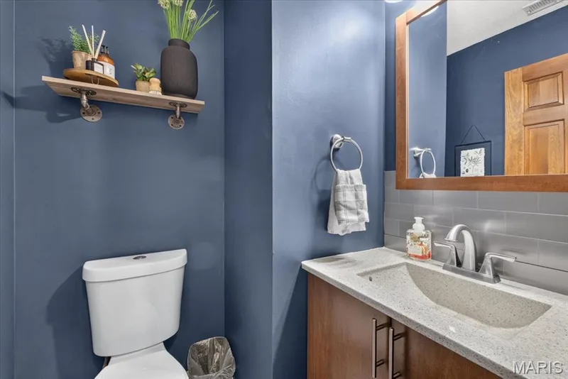 Wood-finish vanity with a light-toned countertop and integrated sink — 1383 Forest Creek Drive #5, St Charles, MO 63303