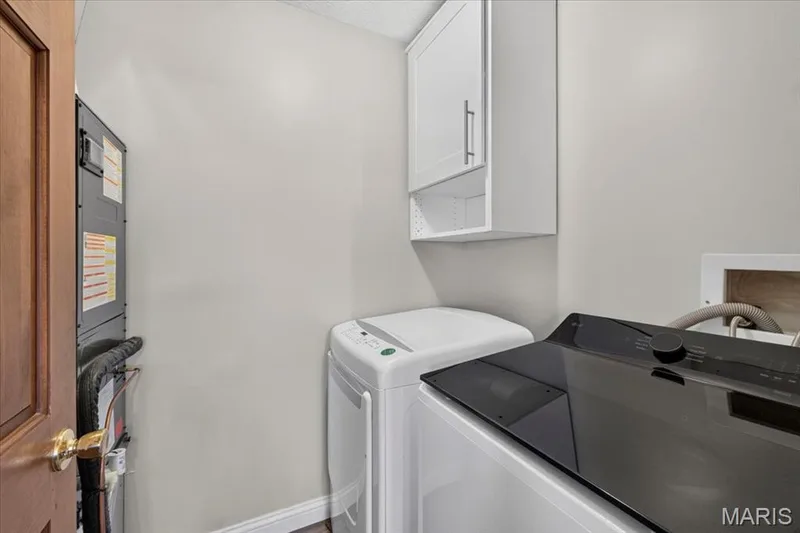 White wall-mounted cabinetry with metal hardware — 1383 Forest Creek Drive #5, St Charles, MO 63303