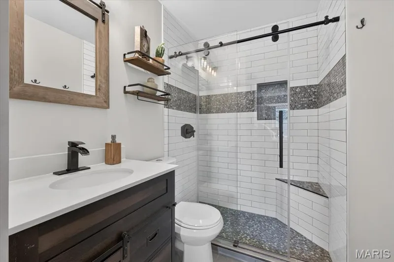 Dark wood-finish vanity with a white countertop and rectangular sink — 1383 Forest Creek Drive #5, St Charles, MO 63303