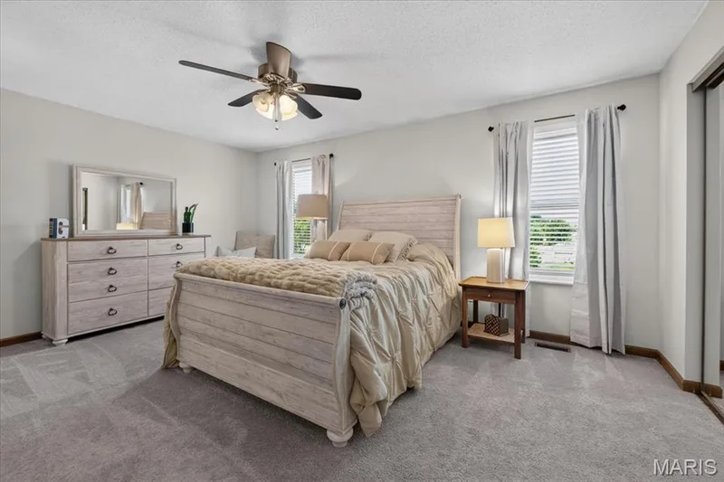 Recessed lighting, ceiling fan with integrated light, carpeted flooring, and two windows with blinds and curtains — 1383 Forest Creek Drive #5, St Charles, MO 63303