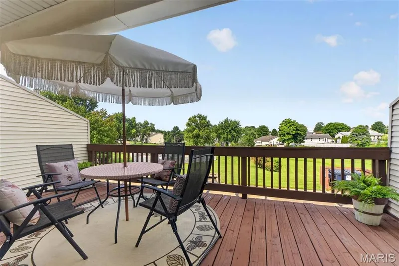 Wood-finish deck with a wood railing and a partial overhead covering — 1383 Forest Creek Drive #5, St Charles, MO 63303