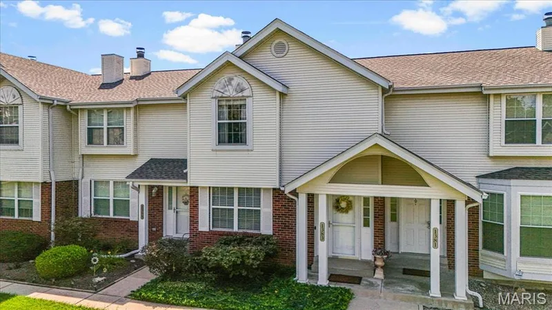 Multi-unit property featuring siding and brick exterior, peaked rooflines, and a covered entry porch — 1383 Forest Creek Drive #5, St Charles, MO 63303
