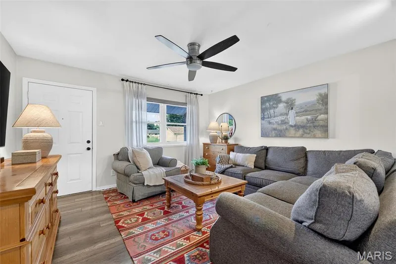 Recessed lighting, wood-finish flooring, white paneled door, ceiling fan with black blades, and large window with blinds — 402 Saint Joseph Avenue, St Charles, MO 63366