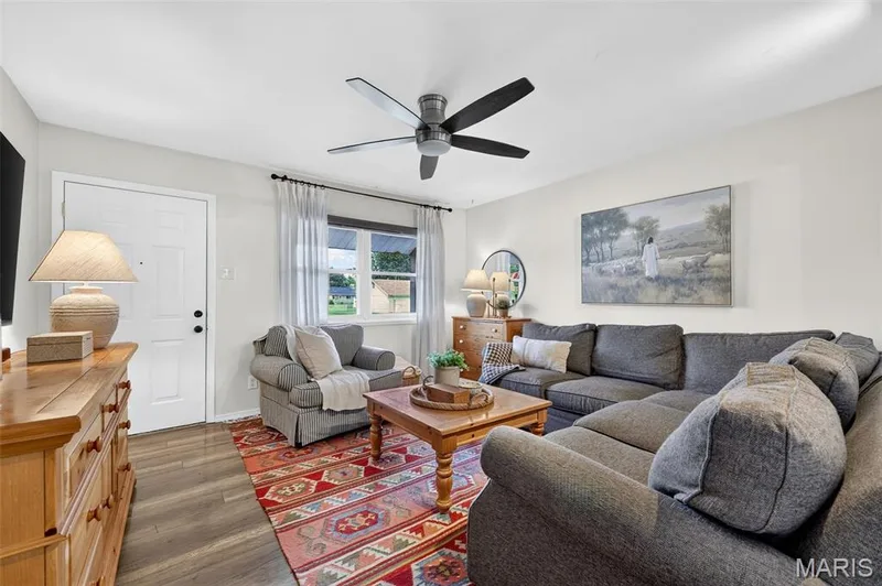 Wood-finish flooring throughout, complemented by a white entry door — 402 Saint Joseph Avenue, St Charles, MO 63366