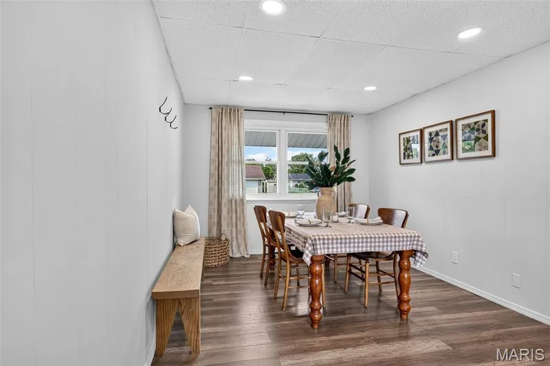 Wood-finish flooring, recessed ceiling lighting, and a large window providing natural illumination — 402 Saint Joseph Avenue, St Charles, MO 63366