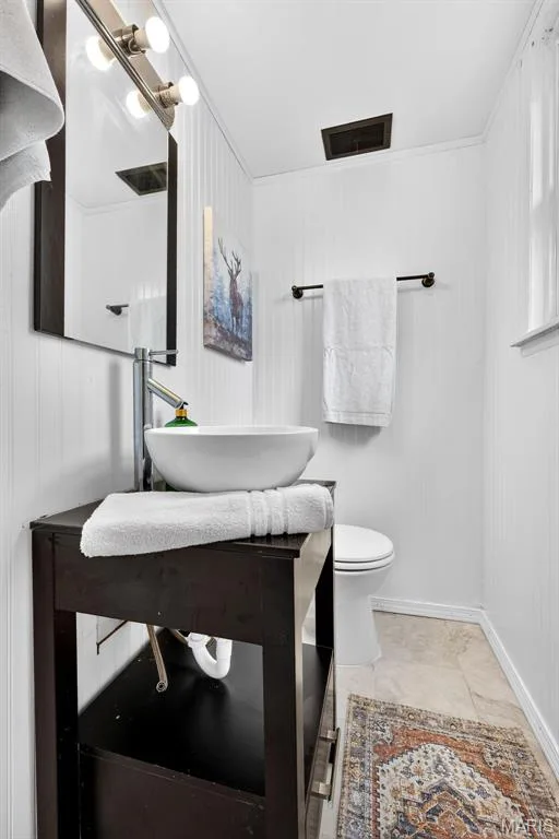 White beadboard walls complement the neutral-toned floor tile — 402 Saint Joseph Avenue, St Charles, MO 63366