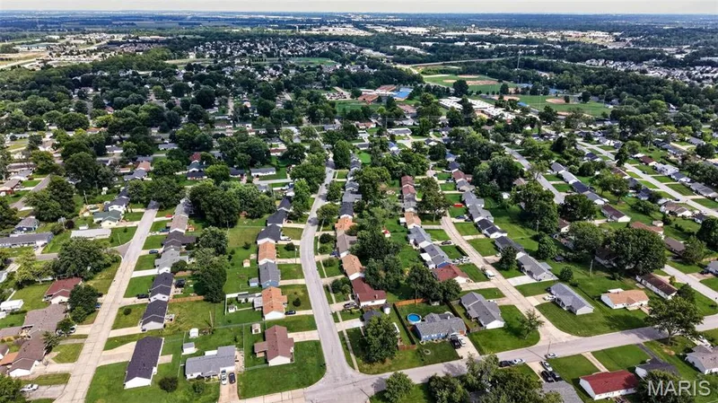 Expansive residential area with numerous single-story homes, mature trees, and paved streets — 402 Saint Joseph Avenue, St Charles, MO 63366