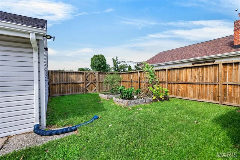 Manicured lawn with a wood privacy fence — 402 Saint Joseph Avenue, St Charles, MO 63366
