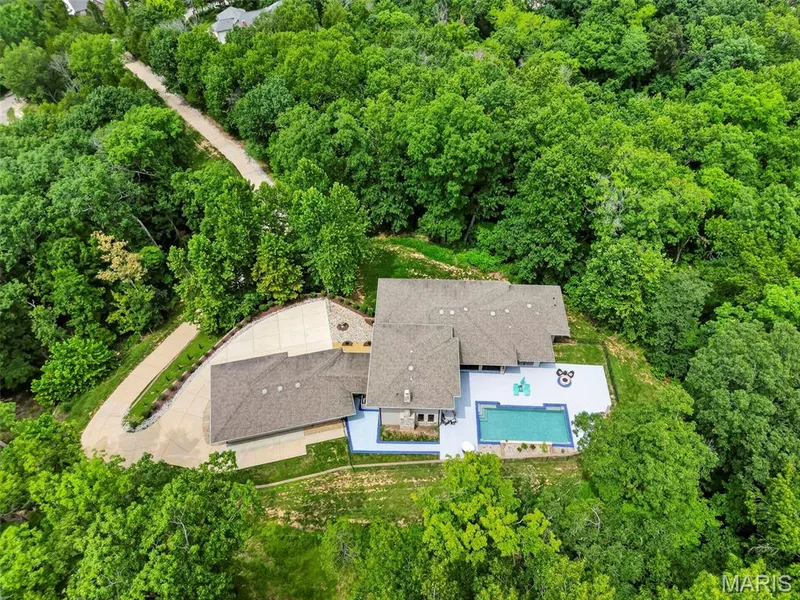 Expansive property with a private driveway, surrounded by mature trees — 19256 Saint Albans Forest Lane, Wildwood, MO 63038
