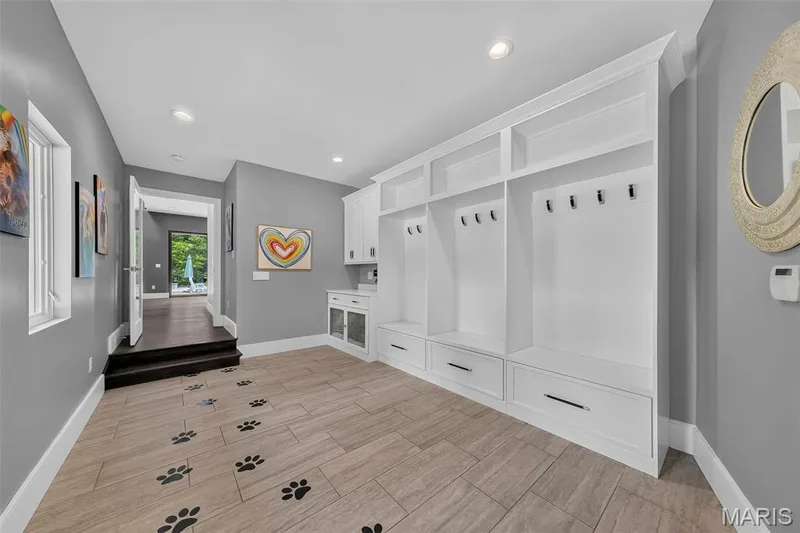 Built-in cabinetry with integrated seating and storage, recessed lighting, and wood-finish flooring — 19256 Saint Albans Forest Lane, Wildwood, MO 63038