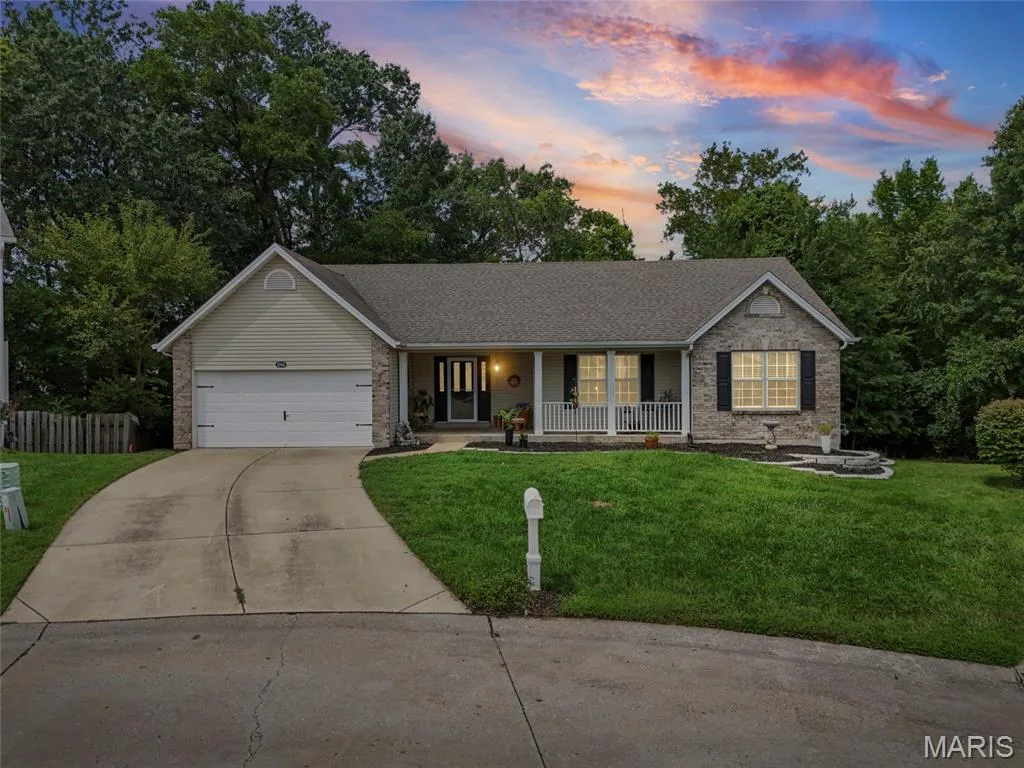 Charming one-story residence showcasing a brick and siding exterior with a covered front porch — 1094 Treeshade Drive, St Peters, MO 63376