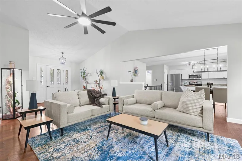 Vaulted ceiling with a ceiling fan, recessed lighting, wood-finish flooring, and white interior doors with decorative glass inserts — 1094 Treeshade Drive, St Peters, MO 63376