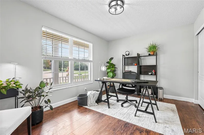 Bright room with wood-finish flooring and a multi-pane window — 1094 Treeshade Drive, St Peters, MO 63376