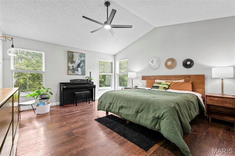 Wood-finish flooring, vaulted ceiling, multi-blade ceiling fan, recessed lighting, and multiple windows — 1094 Treeshade Drive, St Peters, MO 63376