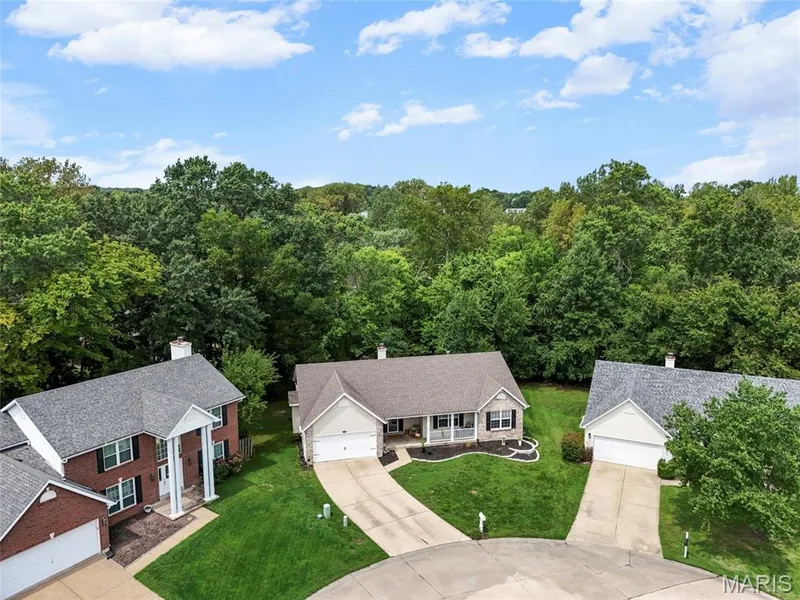 Expansive cul-de-sac lot featuring a two-car garage and a landscaped front yard — 1094 Treeshade Drive, St Peters, MO 63376