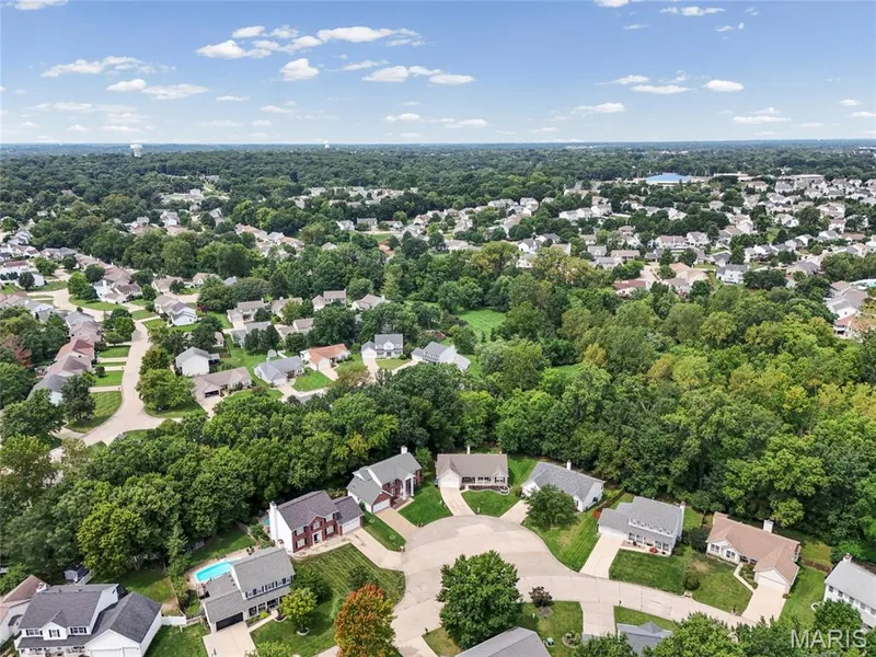 Residential neighborhood with mature tree canopy and varied home styles — 1094 Treeshade Drive, St Peters, MO 63376