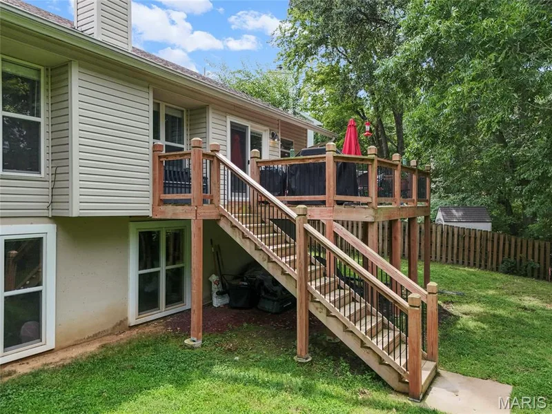 Backyard featuring a newer 2nd story deck with stairs to yard. — 1094 Treeshade Drive, St Peters, MO 63376