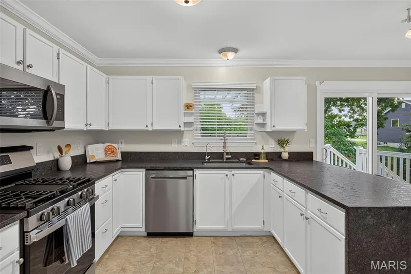 Crown molding accents the walls of the kitchen. — 1761 Fairview Farms Circle, Wentzville, MO 63385