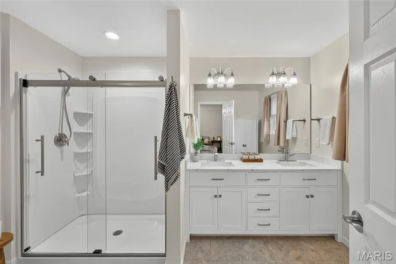Updated primary bathroom now has larger shower, newer flooring, newer double vanity and toilet. — 1761 Fairview Farms Circle, Wentzville, MO 63385
