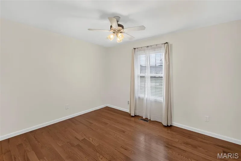 Bedroom #2 has newer hardwood flooring and ceiling fan. — 1761 Fairview Farms Circle, Wentzville, MO 63385