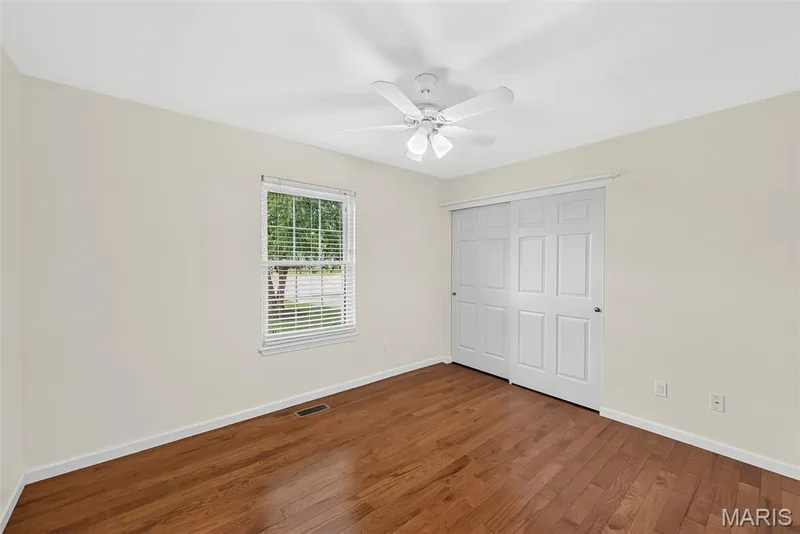 Bedroom #3 has newer hardwood flooring and ceiling fan. — 1761 Fairview Farms Circle, Wentzville, MO 63385