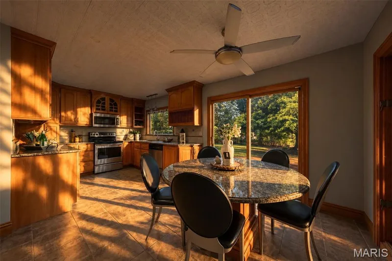 Sunset custom kitchen with solid wood cabinets, solid wood millwork, stainless appliances and granite countertops. — 1028 Monfort Court, Lake St. Louis, MO 63367