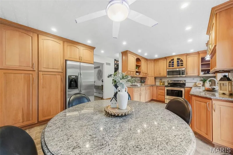 Beautiful custom kitchen with solid wood cabinets, solid wood millwork, stainless appliances and granite countertops. — 1028 Monfort Court, Lake St. Louis, MO 63367