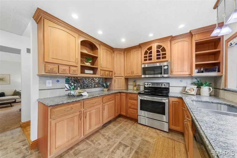 Beautiful custom kitchen with solid wood cabinets, solid wood millwork, stainless appliances and granite countertops. — 1028 Monfort Court, Lake St. Louis, MO 63367