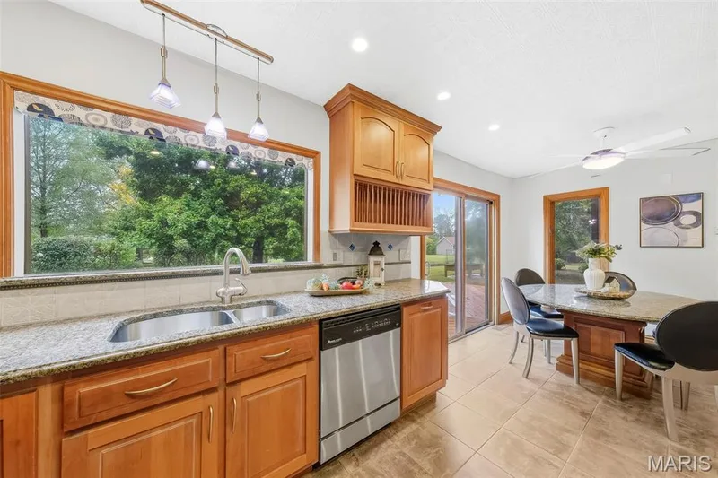 Beautiful custom kitchen with solid wood cabinets, solid wood millwork, stainless appliances and granite countertops. — 1028 Monfort Court, Lake St. Louis, MO 63367