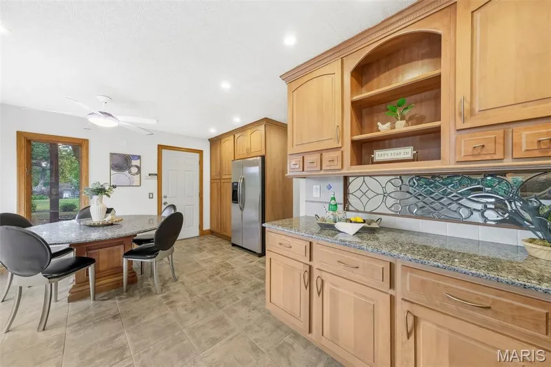 Beautiful custom kitchen with solid wood cabinets, solid wood millwork, stainless appliances and granite countertops. — 1028 Monfort Court, Lake St. Louis, MO 63367