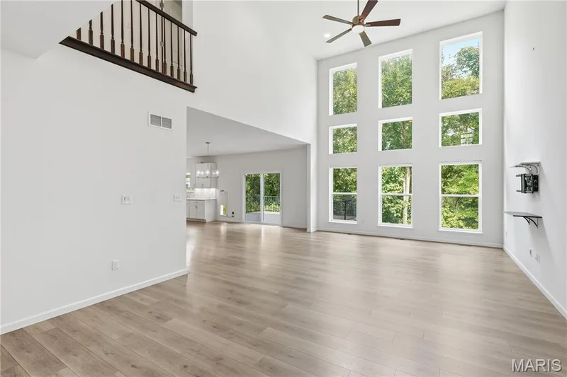 Incredible open floor plan with dramatic 2-story great room with triple row of windows looking out at the wooded common ground behind the property — 1278 Harvester Drive, Chesterfield, MO 63005