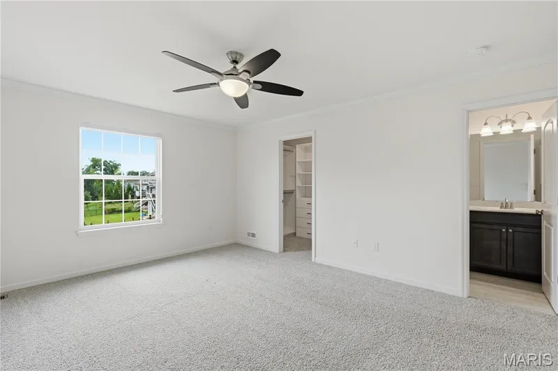 Bedroom with crown molding, ceiling fan, custom closet system and ensuite bath. — 1278 Harvester Drive, Chesterfield, MO 63005