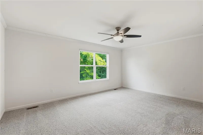 Lovely bedroom with crown molding, ceiling fan, and custom closet system — 1278 Harvester Drive, Chesterfield, MO 63005