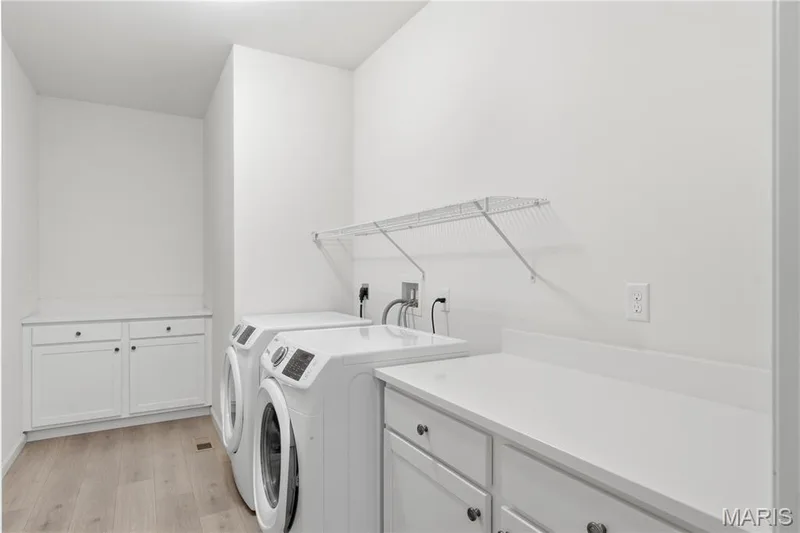 Large main floor laundry room with lots of built-in cabinets and counter space. Washer and Dryer are included — 1278 Harvester Drive, Chesterfield, MO 63005