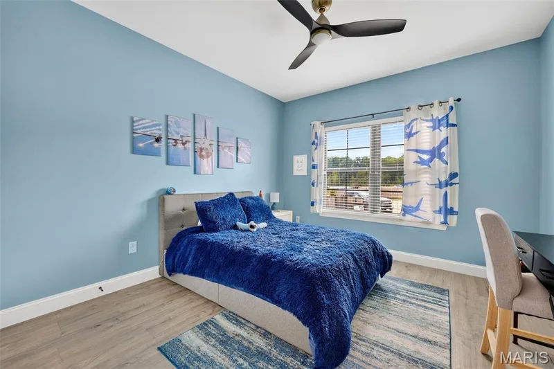 Main level second bedroom with ceiling fan and large window — 155 Haven Ridge Court, Dardenne Prairie, MO 63368