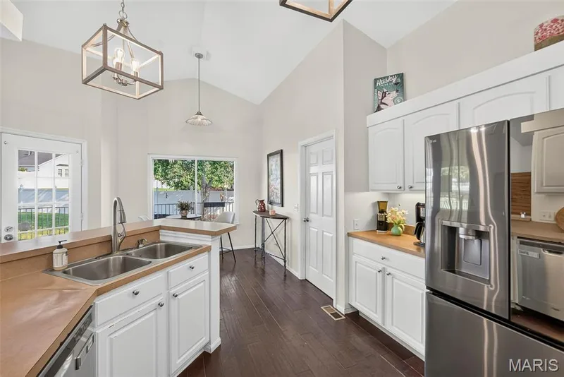 Vaulted kitchen featuring double basin sink — 1509 Langrove Drive, O'Fallon, MO 63368