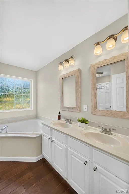 Double sink vanity in primary bathroom — 1509 Langrove Drive, O'Fallon, MO 63368