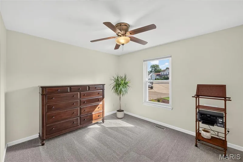 Bedroom with ceiling fan and front yard view — 1509 Langrove Drive, O'Fallon, MO 63368