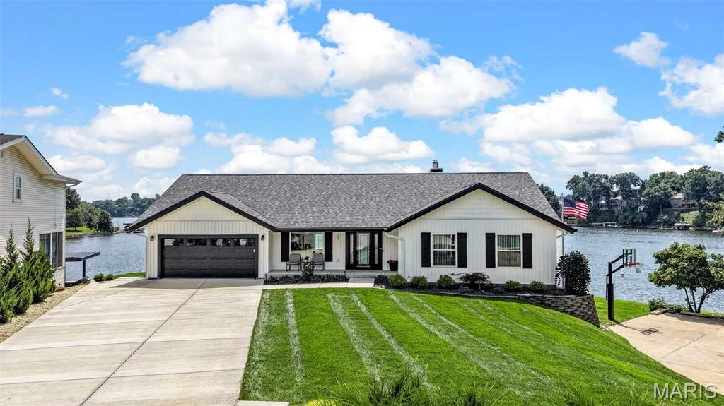 Picture-perfect lakefront living with beautiful curb appeal, lush landscaping and breathtaking Lake Saint Louis views.  Click on the two videos for more! — 22 Harbor Point Court, Lake St. Louis, MO 63367
