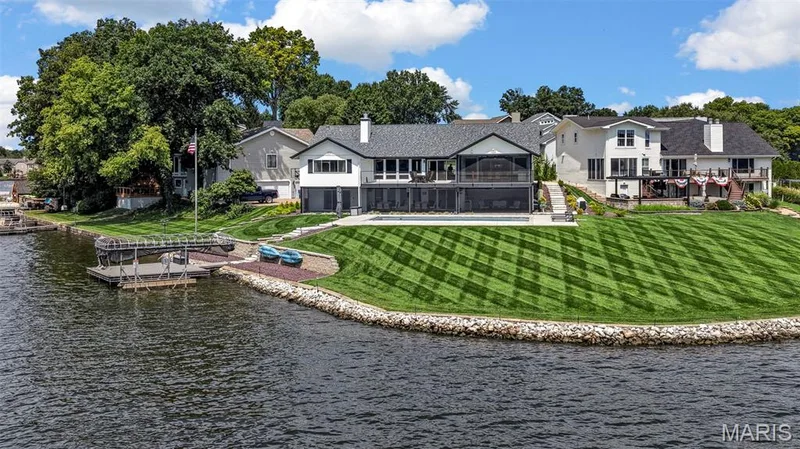 Lakefront living at its finest with an expansive waterfront lawn, private dock and incredible outdoor spaces designed to enjoy life on the lake. — 22 Harbor Point Court, Lake St. Louis, MO 63367