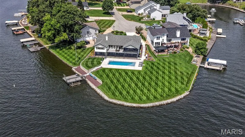 Breathtaking lakefront setting with expansive shoreline, manicured grounds, private pool and spectacular panoramic water views. — 22 Harbor Point Court, Lake St. Louis, MO 63367