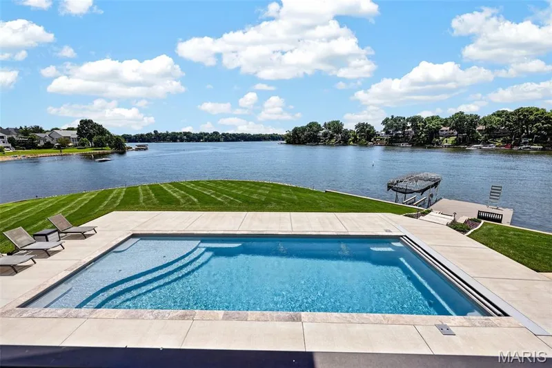 From pool to lake, this is waterfront living at its best—an incredible setting for swimming, boating, entertaining or simply enjoying the view. — 22 Harbor Point Court, Lake St. Louis, MO 63367