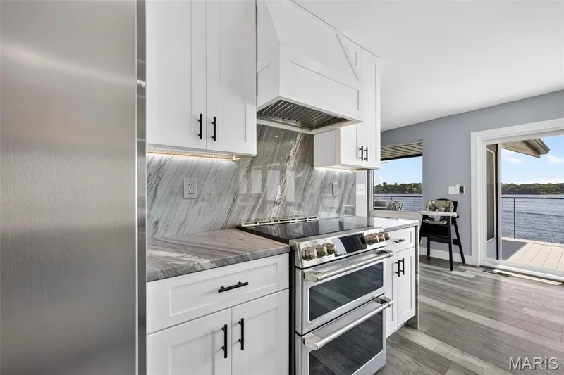 Luxury meets function with stainless steel appliances, custom cabinetry, beautiful stone surfaces and lake views that make even cooking feel like a vacation. — 22 Harbor Point Court, Lake St. Louis, MO 63367