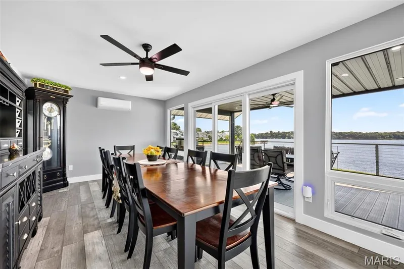 Dinner with a view—this inviting dining space is surrounded by beautiful lake views with seamless access to the screened outdoor living area. — 22 Harbor Point Court, Lake St. Louis, MO 63367