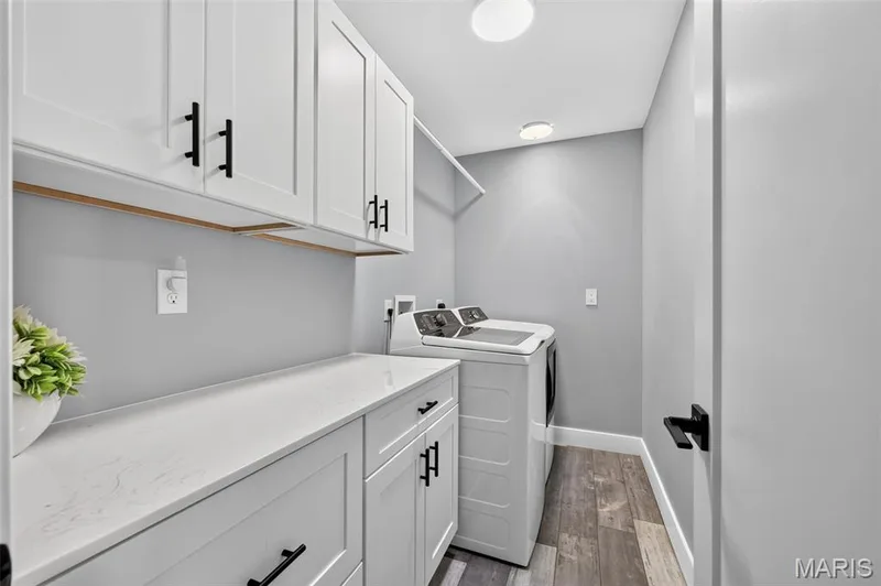 Even laundry feels effortless in this well-designed main-floor laundry room with abundant cabinetry, generous counter space and plenty of storage. — 22 Harbor Point Court, Lake St. Louis, MO 63367
