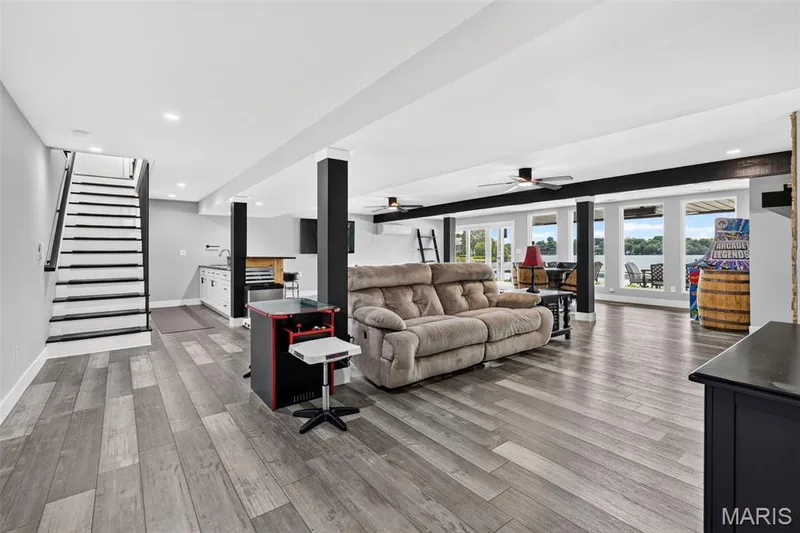 Let the fun begin—an expansive walkout lower-level offering plenty of room for entertaining, games and relaxing, all with beautiful lake views just beyond. — 22 Harbor Point Court, Lake St. Louis, MO 63367