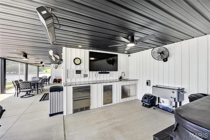 Outdoor Entertaining at its Best! Fully Equipped Outdoor Kitchen with Granite Counters, Refrigerated Drawers, Sink, Built-In Storage and TV, plus Overhead Heaters and Multiple Fans for Extended-Season Enjoyment! — 22 Harbor Point Court, Lake St. Louis, MO 63367