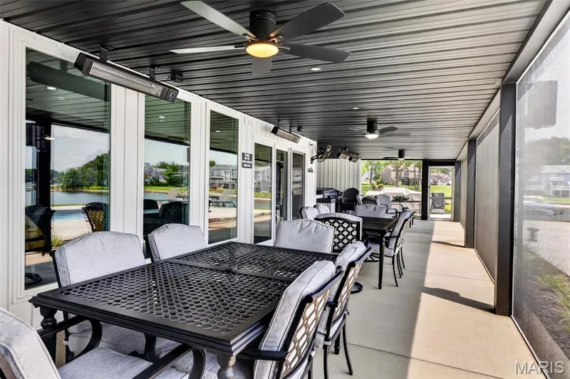 An Entertainer’s Dream! Expansive Screened Outdoor Living Area offers Multiple Dining & Conversation Areas, Ceiling Fans and Overhead Heaters with Beautiful Pool and Lake Views! — 22 Harbor Point Court, Lake St. Louis, MO 63367